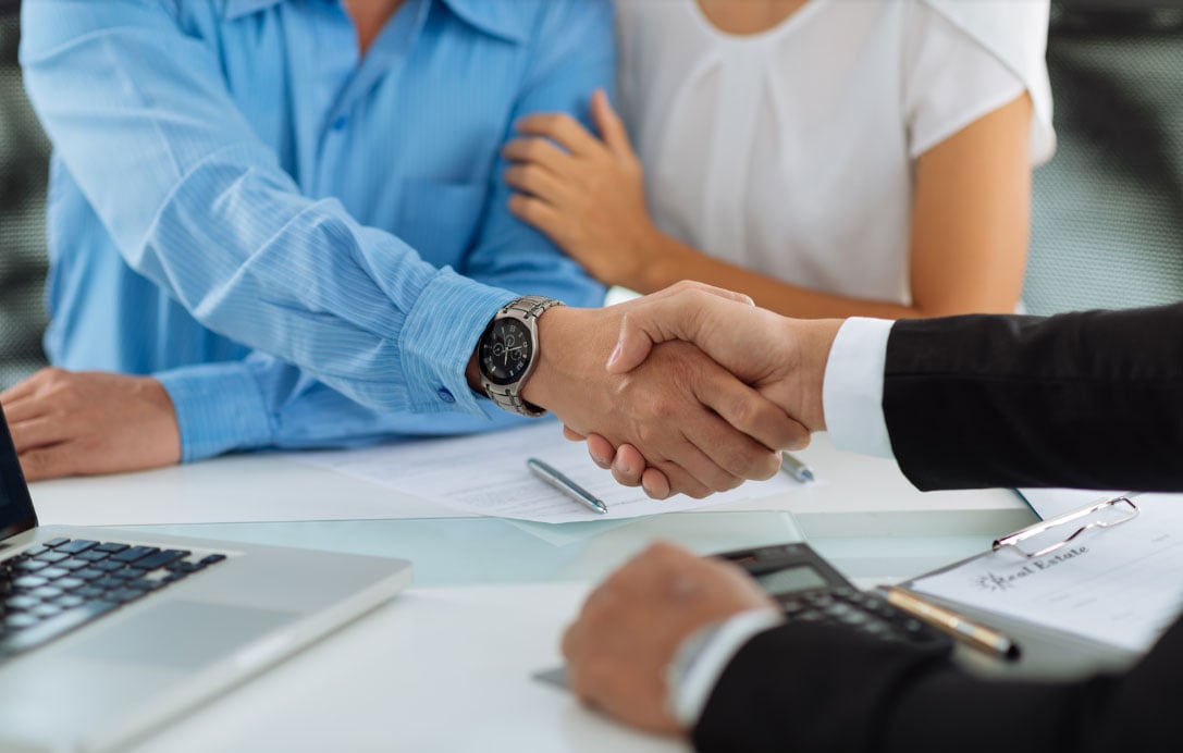 Buyers-and-agent-shake-hands