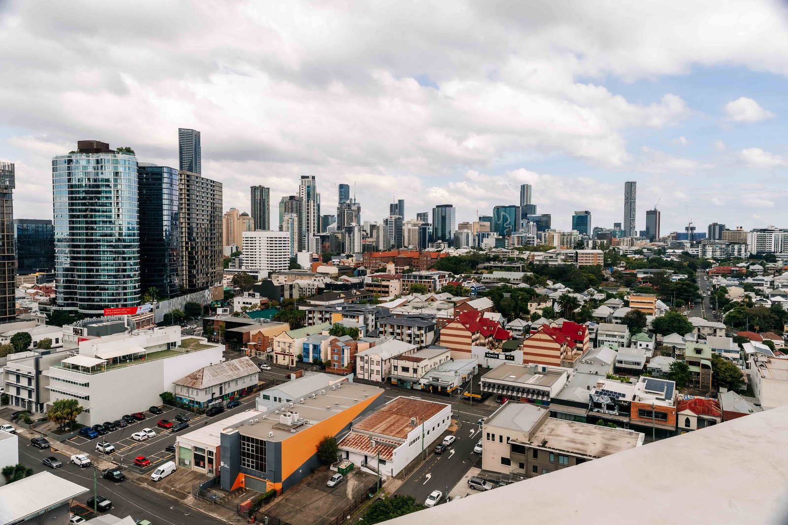 Inner Brisbane rooftops with the city skyline in the distance